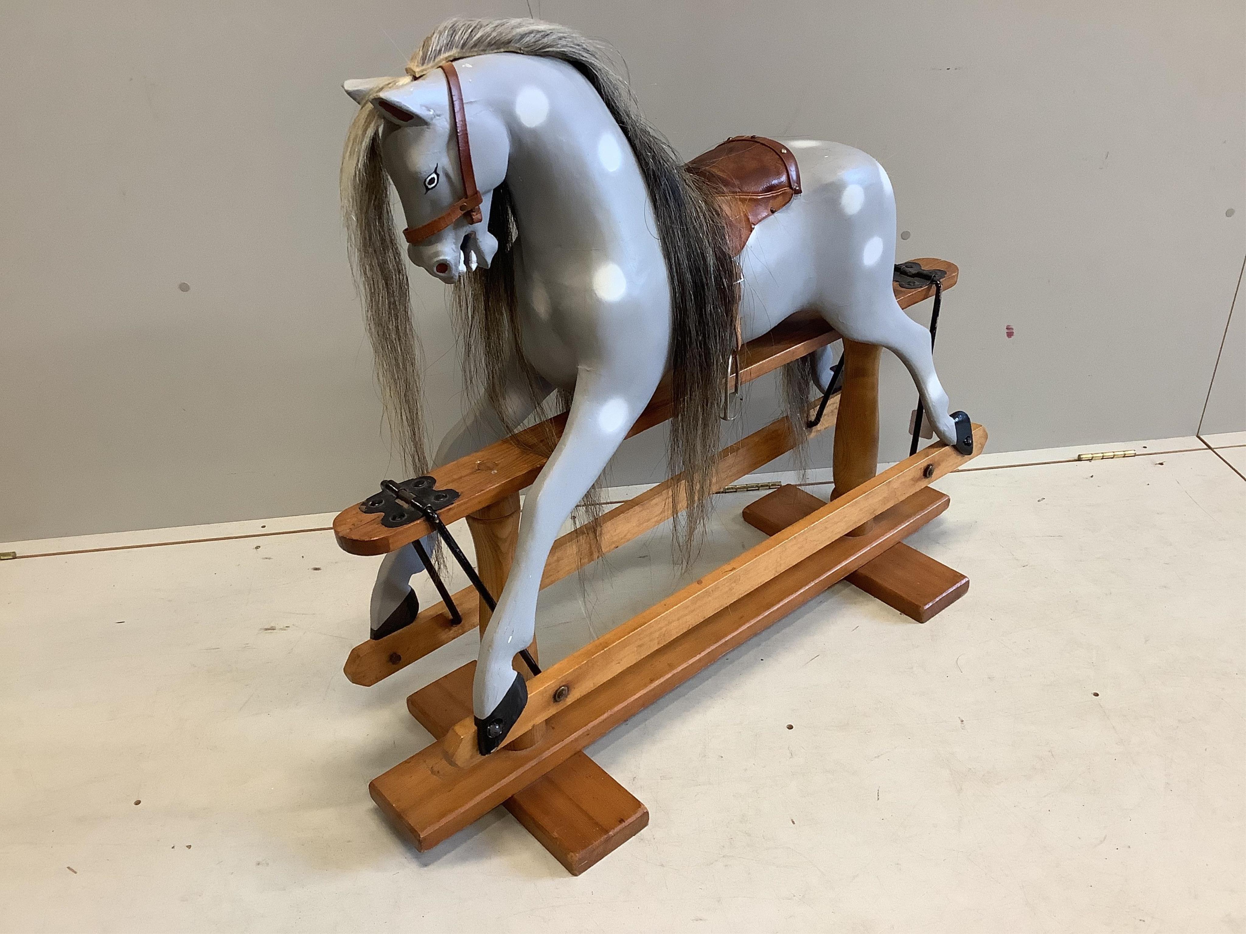 A small 1950's Ayers type dapple grey rocking horse on pine safety frame, later painted, width 106cm, height 95cm. Condition - fair